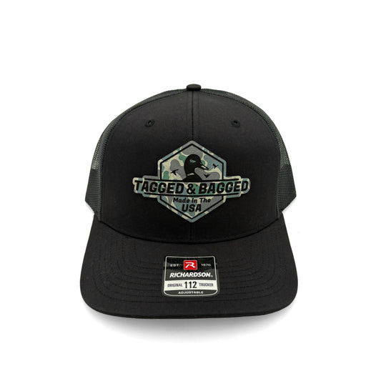 Black cap with camouflage 'Tagged & Bagged' logo