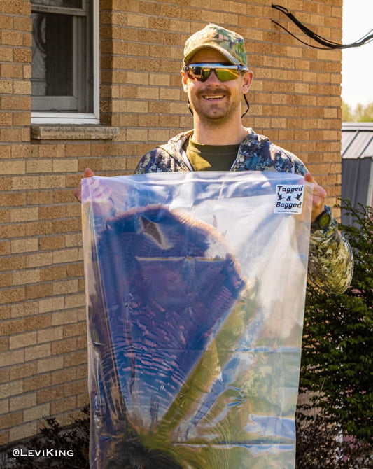 Hunter holding bagged turkey with Tagged and Bagged kit