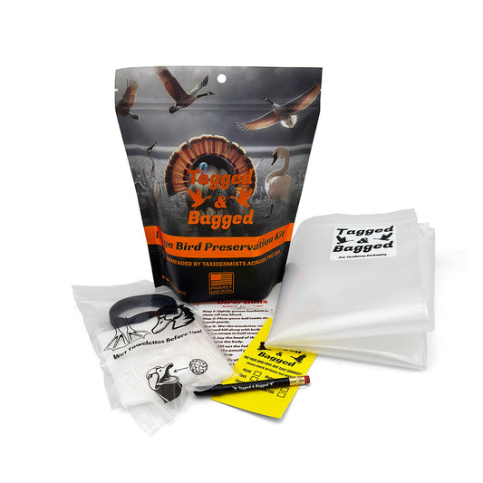 Tagged and Bagged Large Bird Preservation Kit laid out with gauze ball, towelettes, straps, federal toe tag, pencil and preservation bag